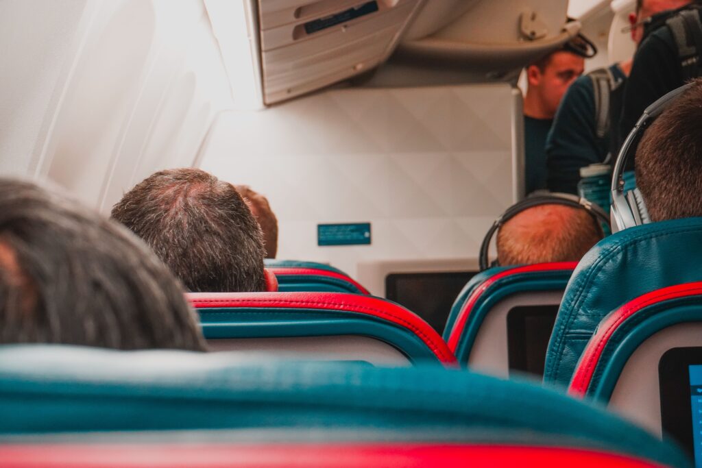 Passengers seated inside a commercial airplane cabin illustrating how airlines can remain profitable even when flights are not completely full.