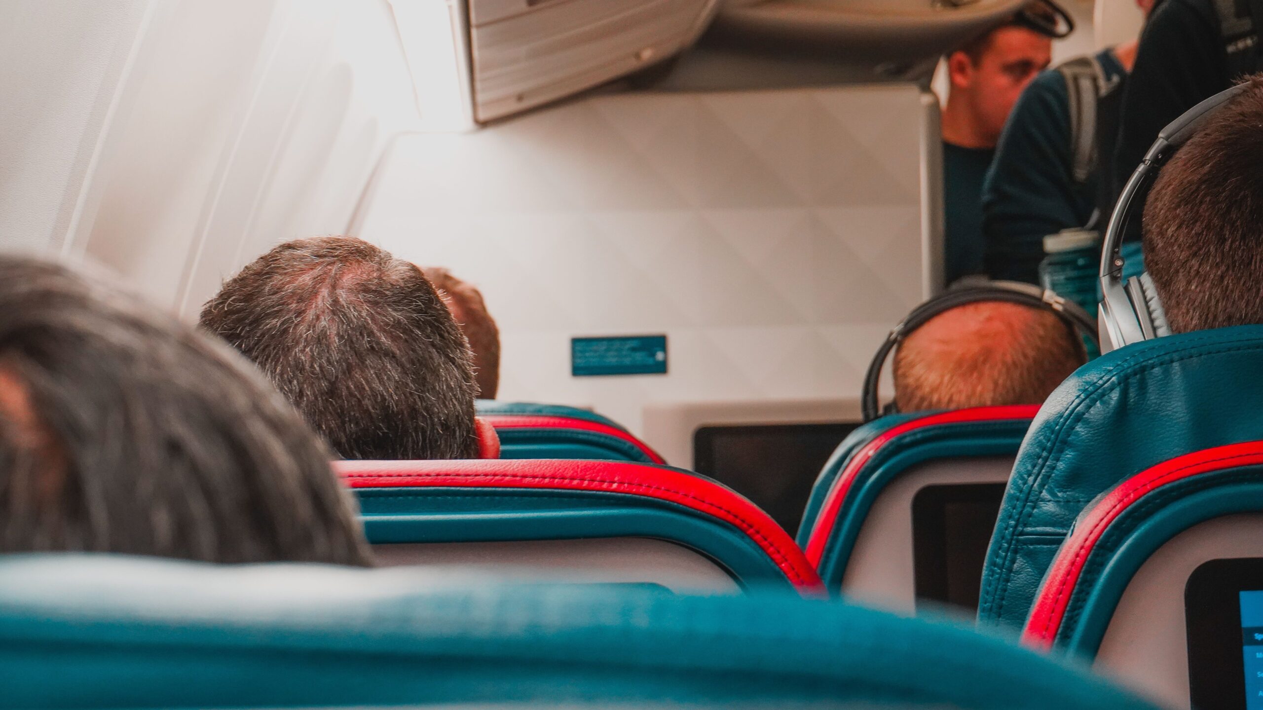 Passengers seated inside a commercial airplane cabin illustrating how airlines can remain profitable even when flights are not completely full.