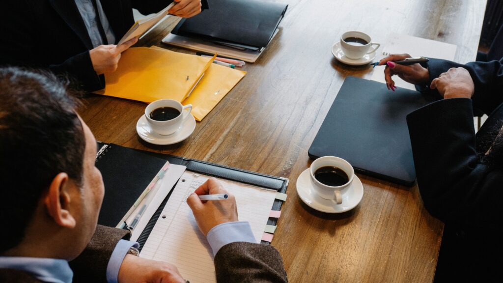 Business professionals meeting around a conference table, representing frequent business travelers who often earn airline elite status through regular work travel.