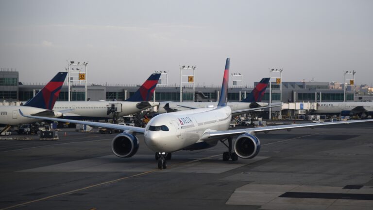 Delta Air Lines aircraft taxiing at a major airport, representing airline loyalty programs and the decision of whether buying airline miles is worth it.