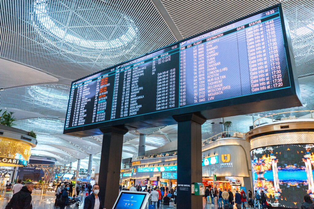International flight departure board at Istanbul Airport showing flights to destinations around the world