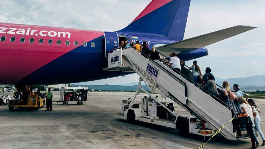 Passengers boarding a Wizz Air flight using stairs at the airport