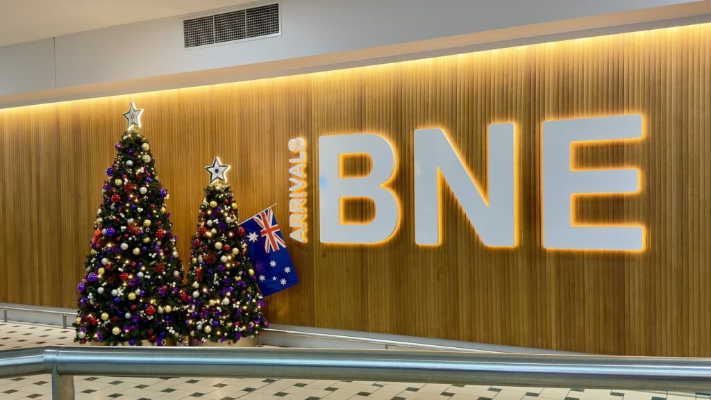 Christmas trees inside Brisbane Airport illustrating holiday travel demand