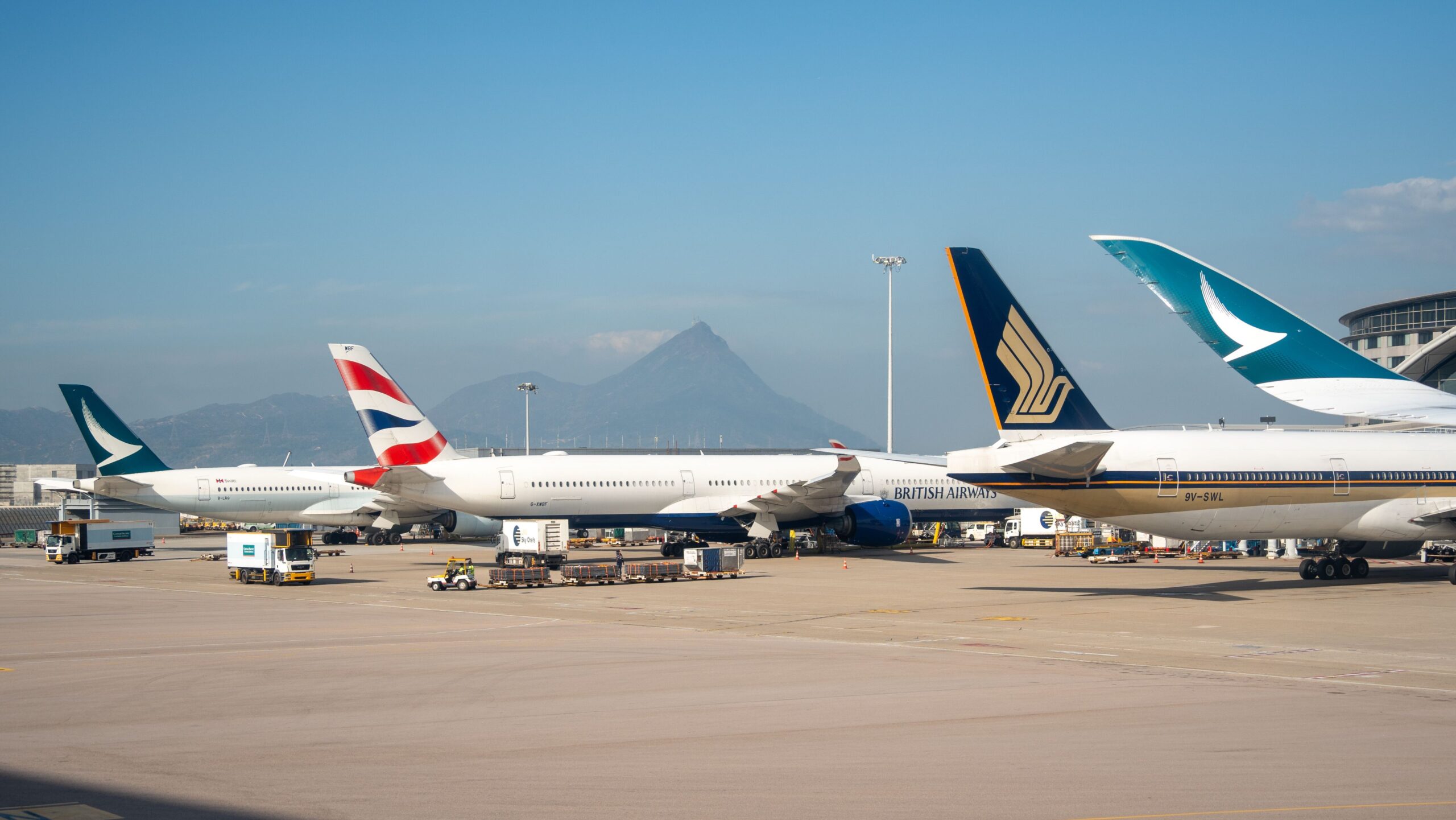 Commercial aircraft parked at airport gates illustrating how airlines price flights through fleet planning, demand forecasting, and revenue management.