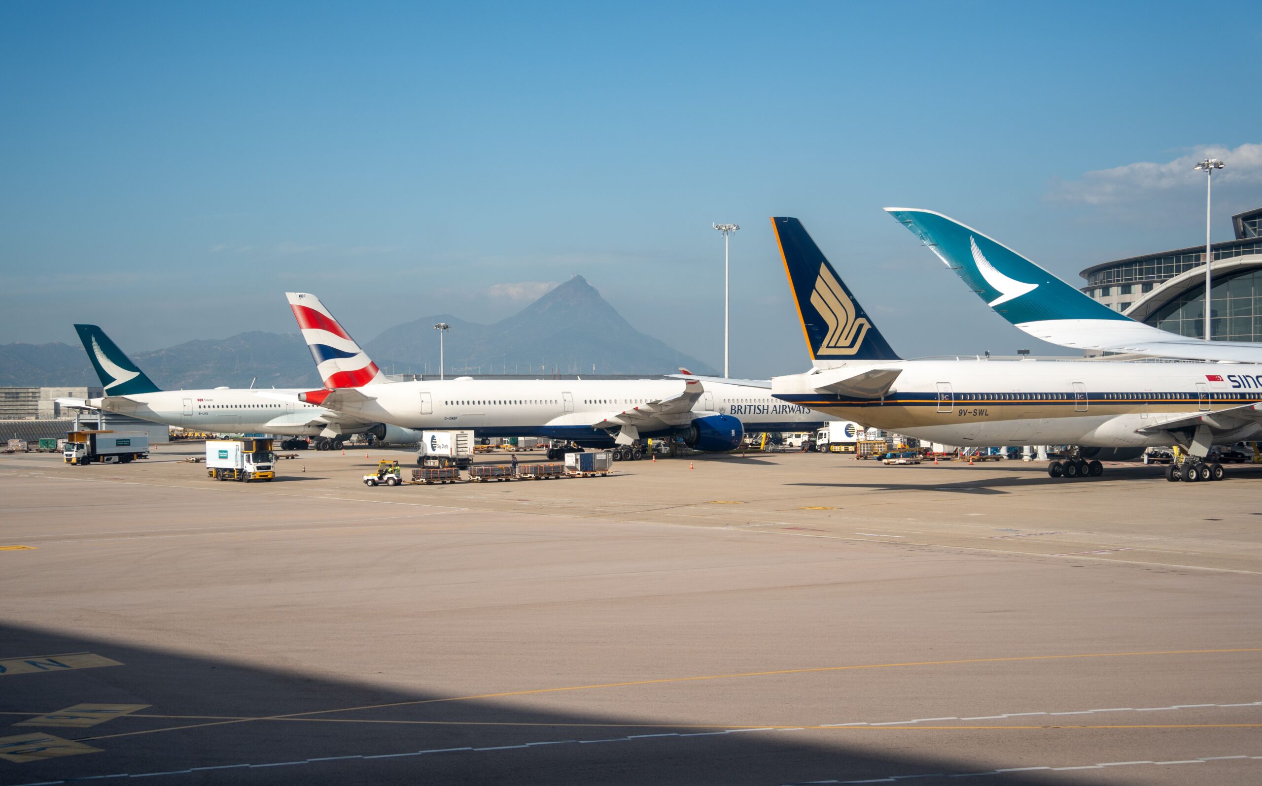 Commercial aircraft parked at airport gates illustrating how airlines price flights through fleet planning, demand forecasting, and revenue management.