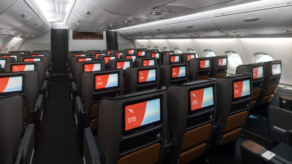 Qantas Airbus A380 Premium Economy cabin with upgraded seats and seatback entertainment screens. Why Travelers Love Free Upgrades