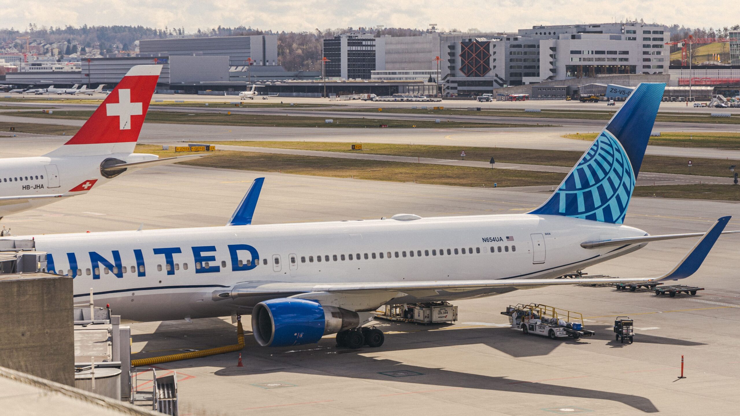 United Airlines aircraft parked at an airport gate, illustrating airline loyalty programs and why buying airline miles is rarely worth it without a specific redemption plan.