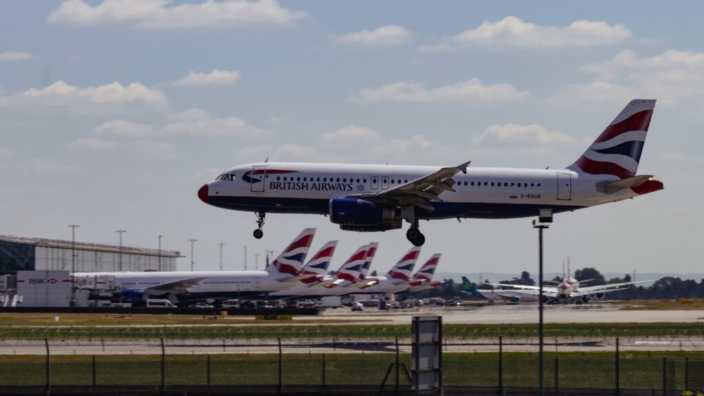 British Airways aircraft landing at London Heathrow Airport with multiple British Airways planes in the background representing one of many airline hubs