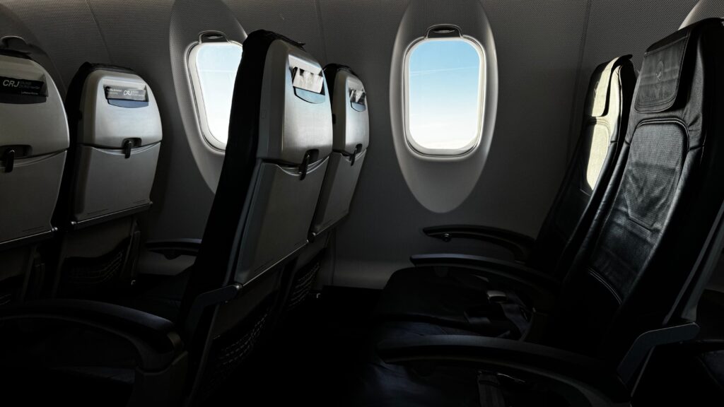 Economy cabin showing airline seat spacing and seat pitch between rows